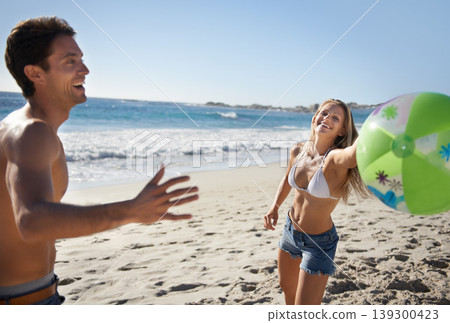 Couple, ball and fun with laughing by beach in summer with love, care and support together on a holiday. Happy, vacation and date by the sea in Miami with freedom and travel by the ocean on a trip 139300423
