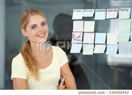 Woman, planning and sticky notes on glass, graph and smile for seminar, creative and portrait. Presentation, strategy and office job for weekly schedule, workplace and financial audit report 139300442