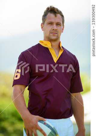 Portrait, ball and a man rugby player outdoor for sports, fitness or training at a club in uniform. Health, exercise and a strong youth athlete on a field for a workout to improve skill or technique Portrait, ball and a man rugby player outdoor for sports, fitness or training at a club in uniform. Health, exercise and a strong youth athlete on a field for a workout to improve skill or technique 139300492
