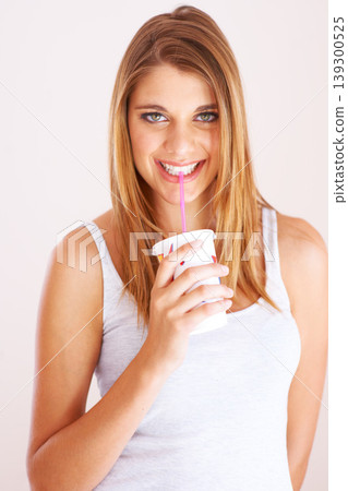 Woman, portrait and drink cup of soda, fizzy cola and ice cold milkshake in studio on white background. Thirsty, happy and young girl sip on straw for takeaway smoothie, juice and fast food beverage 139300525