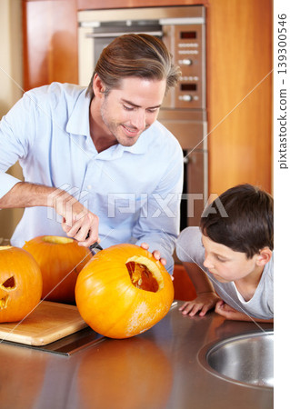 Halloween, pumpkin and father with kid in a kitchen for carving, learning or festival preparation at home. Family, love and parent with fruit, knife and creative lesson while. bonding with boy child Halloween, pumpkin and father with kid in a kitchen for carving, learning or festival preparation at home. Family, love and parent with fruit, knife and creative lesson while. bonding with boy child 139300546