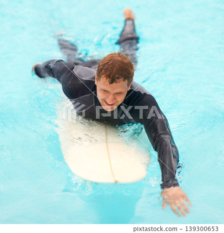 Man, surfing and happy in water, sports and exercise on vacation, holiday and adventure in ocean. Male person, athlete and smile for hobby, paddle and freedom in nature, active and fitness on board Man, surfing and happy in water, sports and exercise on vacation, holiday and adventure in ocean. Male person, athlete and smile for hobby, paddle and freedom in nature, active and fitness on board 139300653