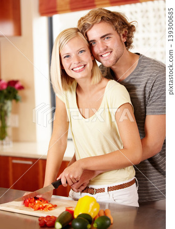 Couple, portrait and cutting vegetables in kitchen for healthy nutrition, dinner meal or vegetarian diet. Man, woman and face for cooking preparation for vitamin food together, home for eating hungry Couple, portrait and cutting vegetables in kitchen for healthy nutrition, dinner meal or vegetarian diet. Man, woman and face for cooking preparation for vitamin food together, home for eating hungry 139300685