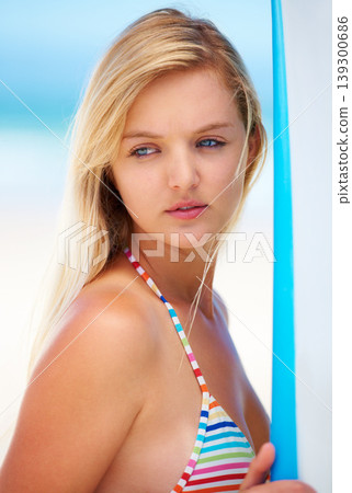 Surf, board and woman at beach thinking about summer, vacation and bikini for holiday. Serious, face and person outdoor in sunshine offshore with confidence and ideas for watersports and travel 139300686
