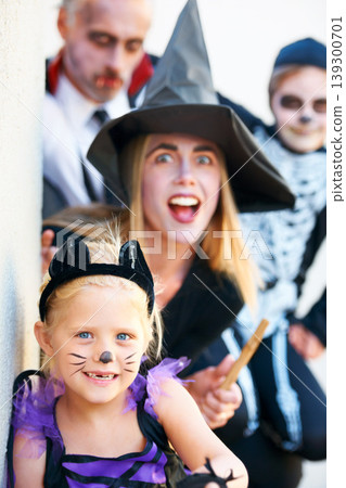 Portrait, halloween and a family in costume for fantasy tradition or holiday celebration. Mother, father and children at a door in trick or treat clothes for dress up on allhallows eve together 139300701