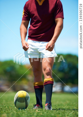 Legs, athlete and player with rugby ball for sports workout or training on a field. Feet, fitness and man ready for competitive exercise in a uniform for sporty fun with an active game outdoors Legs, athlete and player with rugby ball for sports workout or training on a field. Feet, fitness and man ready for competitive exercise in a uniform for sporty fun with an active game outdoors 139300719