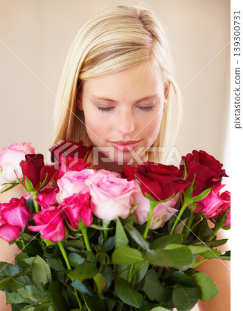 Woman, rose bouquet and eyes closed with face, beauty and arrangement with studio background, happy or gift. Smell, female model or flowers for love, present and valentines day with romantic gesture 139300731