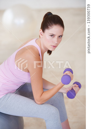 Woman, portrait and dumbbell on ball exercise or fitness routine, active performance for strength practice. Female person, face and weights for health wellness or challenge muscle, strong or training Woman, portrait and dumbbell on ball exercise or fitness routine, active performance for strength practice. Female person, face and weights for health wellness or challenge muscle, strong or training 139300739