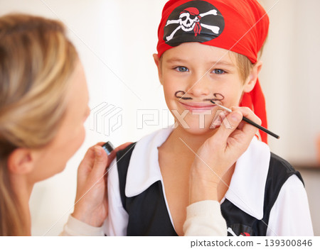 Boy, portrait or pirate face paint with woman, halloween or holiday happiness in childhood in home. Child, mother and theme make up for vacation, clothes and love care for party celebration in house Boy, portrait or pirate face paint with woman, halloween or holiday happiness in childhood in home. Child, mother and theme make up for vacation, clothes and love care for party celebration in house 139300846