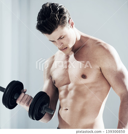 Fitness, dumbbell weight and young man with muscles doing workout in gym for bodybuilding training. Sports, exercise and sexy male person from Canada with equipment for health in wellness center. Fitness, dumbbell weight and young man with muscles doing workout in gym for bodybuilding training. Sports, exercise and sexy male person from Canada with equipment for health in wellness center. 139300850