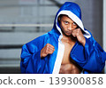 Black man, boxer and champion in robe at gym getting ready for fight, challenge or sports competition. Serious African male person or boxing fighter with fists in preparation for MMA match or game 139300858