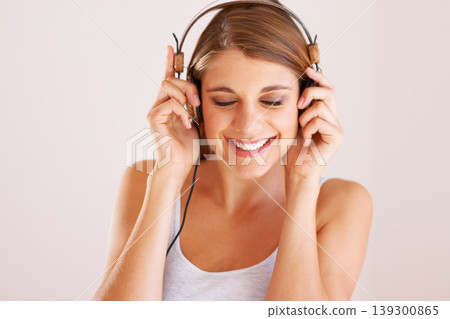 Woman, music and smile with headphones in studio for freedom, audio subscription and streaming multimedia album on white background. Face of happy model listening to podcast, hearing sound and radio Woman, music and smile with headphones in studio for freedom, audio subscription and streaming multimedia album on white background. Face of happy model listening to podcast, hearing sound and radio 139300865