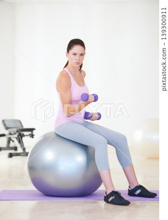 Woman, portrait and exercise ball with dumbbells, balance or gym for training, strong muscle or arms. Girl, workout and fitness with pilates, weightlifting and hard work for health, wellness and body Woman, portrait and exercise ball with dumbbells, balance or gym for training, strong muscle or arms. Girl, workout and fitness with pilates, weightlifting and hard work for health, wellness and body 139300911