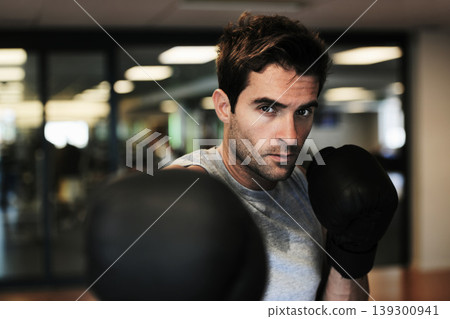 Man, boxing gloves and punch with gym for fitness, wellness or training for fight, performance or sport. MMA, boxer or strong for contest, competition or exercise for development, sweat and workout Man, boxing gloves and punch with gym for fitness, wellness or training for fight, performance or sport. MMA, boxer or strong for contest, competition or exercise for development, sweat and workout 139300941