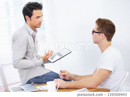 Designer, business men and tablet for discussion, planning project or collaboration for online app at desk in office. Creative teamwork, digital technology or conversation of advice in startup agency 139300943