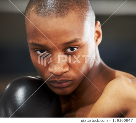 Boxing, gloves and portrait of fearless black man training with fitness, power and workout challenge. Strong body, muscle and boxer in gym, athlete with fist up and confidence in competition fighting 139300947