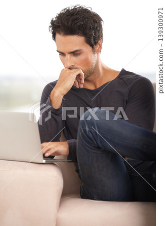 Man, work from home and thinking on laptop for stock market investment, reading information or website on sofa. Freelancer or trader on his computer with trading software, choice or online decision Man, work from home and thinking on laptop for stock market investment, reading information or website on sofa. Freelancer or trader on his computer with trading software, choice or online decision 139300971