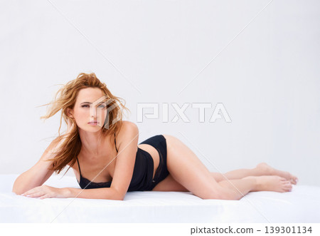 Beauty, bed and woman in lingerie on a white background for sensual, desire and flirting. Lying, resting and sexy person in bedroom with confidence, pride and model in underwear, bra and panties Beauty, bed and woman in lingerie on a white background for sensual, desire and flirting. Lying, resting and sexy person in bedroom with confidence, pride and model in underwear, bra and panties 139301134