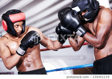 Boxing, black man and sparring partner in ring together with headgear, gloves and fitness, power training, challenge. Strong body, fighting and boxer in helmet, fearless and confident in competition. Boxing, black man and sparring partner in ring together with headgear, gloves and fitness, power training, challenge. Strong body, fighting and boxer in helmet, fearless and confident in competition. 139301219
