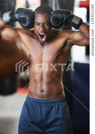 Boxing, gloves and portrait of black man shouting in gym with fitness, power and training challenge. Strong body, muscle and boxer in club, athlete with motivation and confidence in competition fight Boxing, gloves and portrait of black man shouting in gym with fitness, power and training challenge. Strong body, muscle and boxer in club, athlete with motivation and confidence in competition fight 139301294