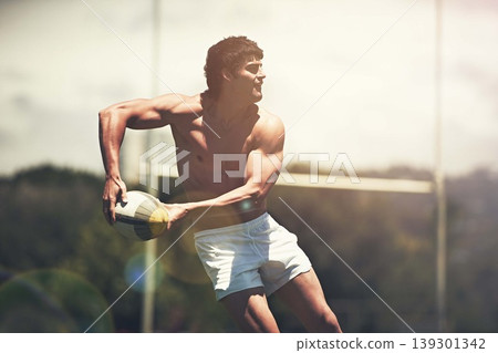 Rugby, sports and fitness man with ball on field for training, wellness or morning cardio outdoor. Handball, exercise and topless male player running at stadium for competition, action or performance 139301342