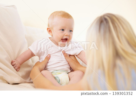 Mother, baby and laughing at home, play and child development or love, security and bonding. Mom, kid and connection or fun, joy and care in motherhood, happiness and smile or learn to communicate Mother, baby and laughing at home, play and child development or love, security and bonding. Mom, kid and connection or fun, joy and care in motherhood, happiness and smile or learn to communicate 139301352