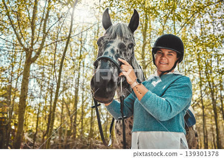 Portrait of woman with horse in woods, smile and pride for competition, race or dressage with trees. Equestrian sport, face of jockey or rider with animal in forest for adventure, training and care. Portrait of woman with horse in woods, smile and pride for competition, race or dressage with trees. Equestrian sport, face of jockey or rider with animal in forest for adventure, training and care. 139301378