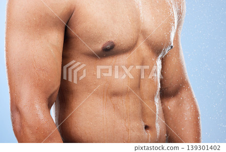 Torso water drops, body shower and person wet, grooming or morning self care, maintenance or cleaning stomach. Bathroom liquid, bath or studio model hygiene, strong abdomen or wash on blue background 139301402