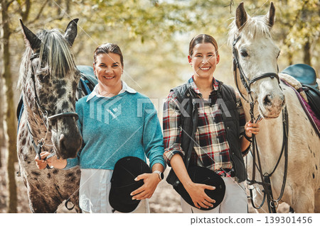Smile, nature and portrait of women with horses in forest training for race, competition or event. Happy, animal and young female people with stallion pets outdoor in woods for equestrian practice. Smile, nature and portrait of women with horses in forest training for race, competition or event. Happy, animal and young female people with stallion pets outdoor in woods for equestrian practice. 139301456