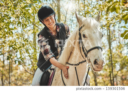 Portrait of happy woman on horse, riding in woods and practice for competition, race or dressage with trees. Equestrian sport, jockey or rider on animal in forest for adventure, training and smile. Portrait of happy woman on horse, riding in woods and practice for competition, race or dressage with trees. Equestrian sport, jockey or rider on animal in forest for adventure, training and smile. 139301506