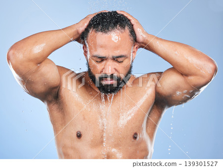 Shower, washing hair and man with water in studio for cleaning, hygiene and skincare on blue background. Dermatology, bathroom and person with drops or splash for wellness, grooming and self care Shower, washing hair and man with water in studio for cleaning, hygiene and skincare on blue background. Dermatology, bathroom and person with drops or splash for wellness, grooming and self care 139301527