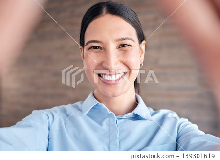 Selfie, face and a business woman in her office to update her social media profile picture. Portrait, smile and a happy young employee posing for a photograph as a professional in the workplace Selfie, face and a business woman in her office to update her social media profile picture. Portrait, smile and a happy young employee posing for a photograph as a professional in the workplace 139301619