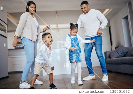 Dance, love and energy with a family having fun in the living room of their home together. Freedom, smile or happy with a mother, father and excited children moving or playing in their apartment Dance, love and energy with a family having fun in the living room of their home together. Freedom, smile or happy with a mother, father and excited children moving or playing in their apartment 139301622