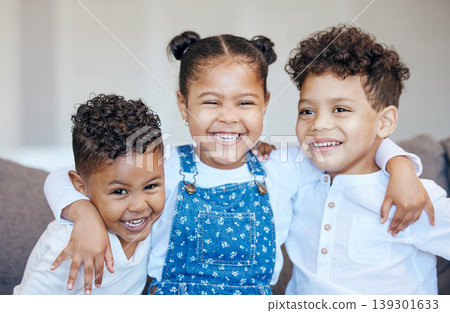 Sibling, children and hug with smile in portrait on sofa in living room for memory, milestone or growth. Boy, girl or happiness on face for bond, relationship or care with embrace for love in support Sibling, children and hug with smile in portrait on sofa in living room for memory, milestone or growth. Boy, girl or happiness on face for bond, relationship or care with embrace for love in support 139301633