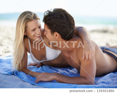 Beach, couple and embrace with smile, support and care on holiday travel by sea and ocean. Romance, bonding and kiss with young people together on vacation adventure on sand on a date with love 139301860