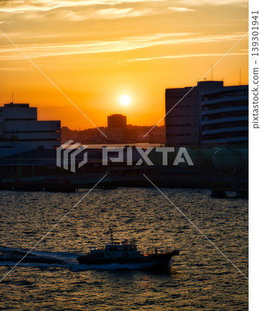 A pilot boat (with a harbor pilot) sailing through Yokohama Port at sunrise. A pilot boat (with a harbor pilot) sailing through Yokohama Port at sunrise. 139301941