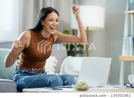 Woman, winner and yes on laptop and sofa for online education, e learning or virtual school results at home. Excited student with fist, cheers and reading email or news of winning on her computer Woman, winner and yes on laptop and sofa for online education, e learning or virtual school results at home. Excited student with fist, cheers and reading email or news of winning on her computer 139301961