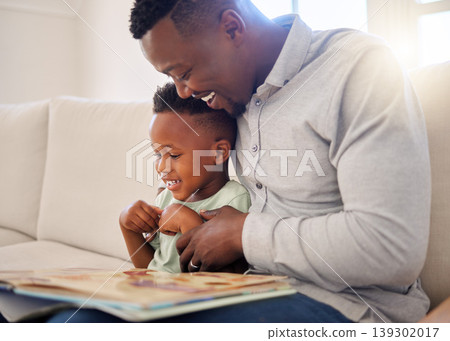 African, father and child in home reading book on sofa with development of language, education and learning. Happy dad, teaching and show kid a storytelling in books and relax in living room on couch African, father and child in home reading book on sofa with development of language, education and learning. Happy dad, teaching and show kid a storytelling in books and relax in living room on couch 139302017