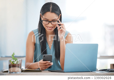 Happy business woman, laptop and phone for communication, networking or social media at office. Female person or employee smile on mobile smartphone in online chatting, texting or search at workplace Happy business woman, laptop and phone for communication, networking or social media at office. Female person or employee smile on mobile smartphone in online chatting, texting or search at workplace 139302028