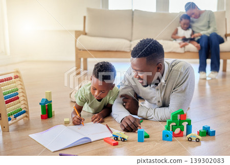 Family, man and boy with book on floor, lying and living room with love, care and support for education. Father, son and together with toy, blocks or pen for child development, growth or learning Family, man and boy with book on floor, lying and living room with love, care and support for education. Father, son and together with toy, blocks or pen for child development, growth or learning 139302083