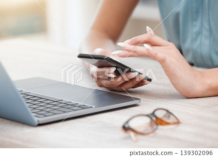 Hands, phone and a business woman at a desk in her office for communication, networking or search. Laptop, planning and glasses with an employee typing a text message closeup in the workplace Hands, phone and a business woman at a desk in her office for communication, networking or search. Laptop, planning and glasses with an employee typing a text message closeup in the workplace 139302096