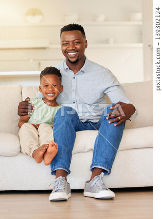 Happy, smile and portrait of child with father on sofa in the living room of modern house for bonding. Care, love and young African boy kid sitting with his dad on couch of lounge at home together. Happy, smile and portrait of child with father on sofa in the living room of modern house for bonding. Care, love and young African boy kid sitting with his dad on couch of lounge at home together. 139302124