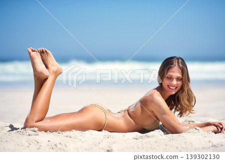 Woman, relax and tanning on beach sand at vacation for nature water, sea rest or holiday travel location. Female person, bikini and clean air for outdoor sunshine, tourism peace at blue sky coast Woman, relax and tanning on beach sand at vacation for nature water, sea rest or holiday travel location. Female person, bikini and clean air for outdoor sunshine, tourism peace at blue sky coast 139302130