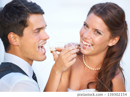 Portrait, wedding cake and couple with smile, feeding and commitment celebration at luxury event together. Sharing dessert, eating and woman with man at marriage with tradition, loyalty and love. Portrait, wedding cake and couple with smile, feeding and commitment celebration at luxury event together. Sharing dessert, eating and woman with man at marriage with tradition, loyalty and love. 139302154