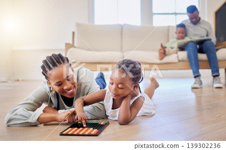 Education, smile and black woman playing with kid on the floor in the living room at modern home. Abacus, mathematics and young African mother helping girl child with counting at house together. 139302236