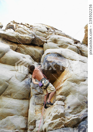 Man, mountain and rock climbing or chalk for grip as outdoor performance, adventure or gear. Male person, hanging and rope on cliff or fearless danger on boulder stone, training for exercise discover Man, mountain and rock climbing or chalk for grip as outdoor performance, adventure or gear. Male person, hanging and rope on cliff or fearless danger on boulder stone, training for exercise discover 139302256