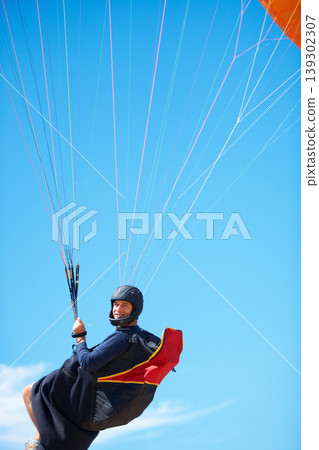 Man, portrait and paragliding in blue sky parachute for adventure fun, clouds or explore city. Male person, face and outdoor courage for fearless athlete or landing equipment, air safety in nature 139302307