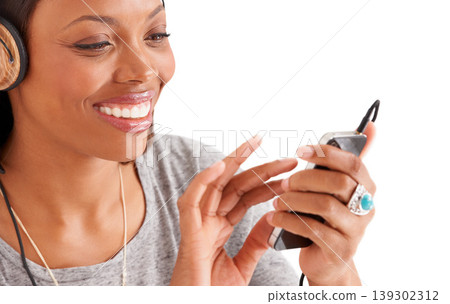 Happy black woman, phone and headphones for music or audio streaming against a white studio background. Face of African female person on mobile smartphone app for sound track, playlist or podcast Happy black woman, phone and headphones for music or audio streaming against a white studio background. Face of African female person on mobile smartphone app for sound track, playlist or podcast 139302312
