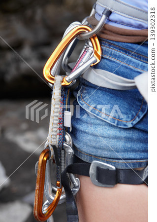 Woman, carabiner and rock climbing gear closeup or rope safety, support adventure on danger exercise. Athlete person, mountain and clip for cliff sport or belt hook for extreme, equipment for explore Woman, carabiner and rock climbing gear closeup or rope safety, support adventure on danger exercise. Athlete person, mountain and clip for cliff sport or belt hook for extreme, equipment for explore 139302318