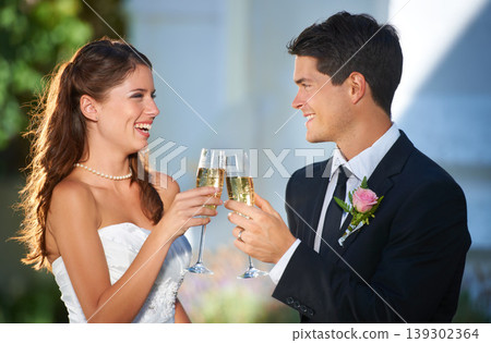 Happy couple, wedding and cheers with champagne glasses in celebration for marriage, love or commitment. Married man and woman smile with alcohol for toast, date or honeymoon at outdoor ceremony Happy couple, wedding and cheers with champagne glasses in celebration for marriage, love or commitment. Married man and woman smile with alcohol for toast, date or honeymoon at outdoor ceremony 139302364
